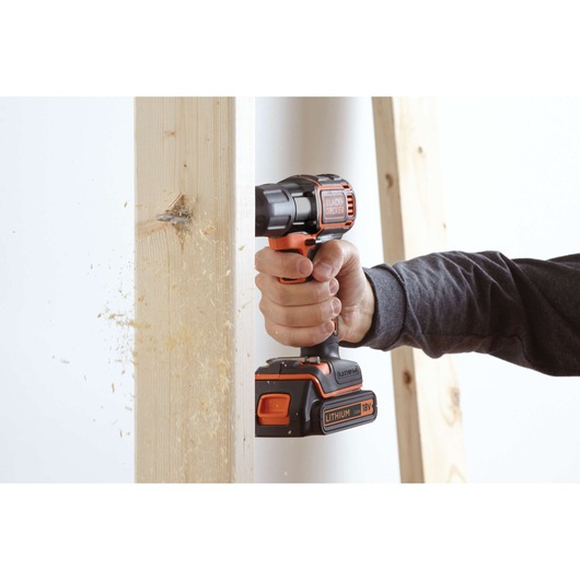 BLACKDECKER ASD18K cordless drill in use, drilling through wood, close-up angle.