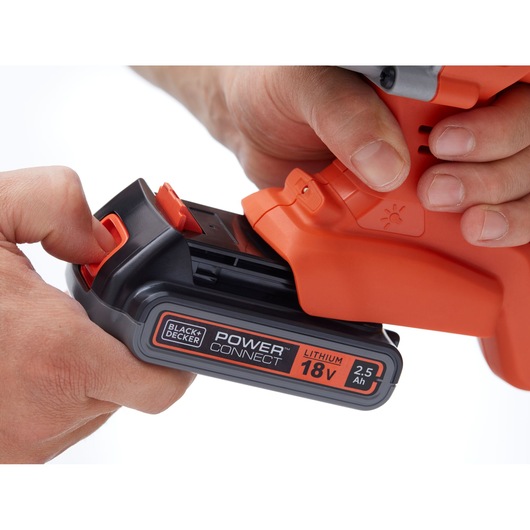 Close-up of BLACK+DECKER BCD900E2K power tool with 18V lithium 2.5Ah POWERCONNECT battery being inserted.