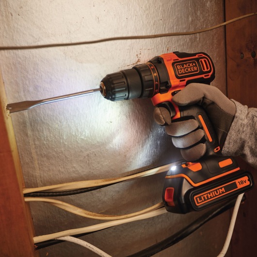 Photo of a BLACK+DECKER BDCDD186KB cordless drill with 18V lithium battery used for drilling near electrical wires.