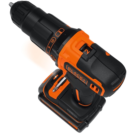 A close-up view of a BLACK+DECKER cordless power drill with orange and black detailing, showing the drill bit and battery pack.