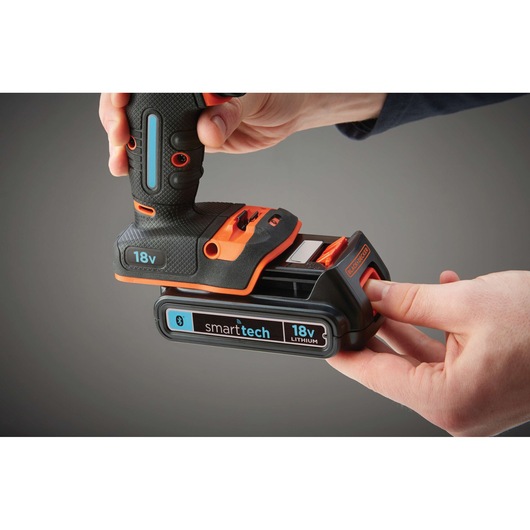 Photo of BLACKDECKER BDCHD18KST 18V cordless drill with smarttech lithium battery being attached by hand.