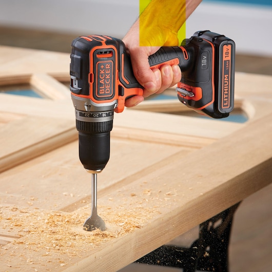 Photo of BLACKDECKER BL186K cordless drill with 18V lithium battery drilling wood surface.