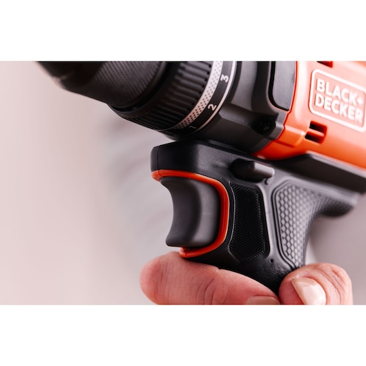 Close-up photo of BLACK+DECKER BLD682D1 drill, focusing on the black and orange ergonomic grip and trigger.