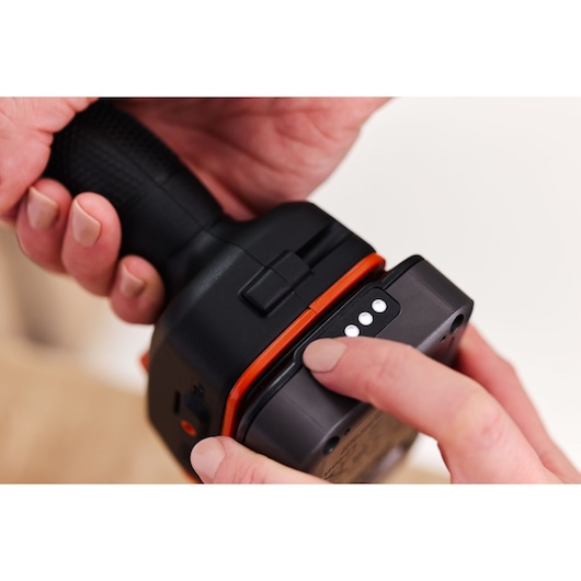 Close-up photo of BLACKDECKER BLD682D1 power tool showing battery indicator lights being pressed.