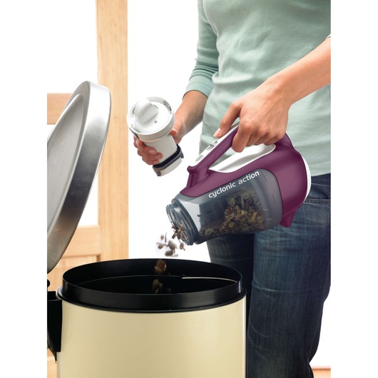 BLACKDECKER DV9610ECN handheld vacuum photography showing dust being emptied into a trash bin.