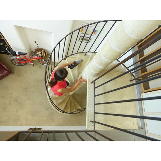 BLACKDECKER DVJ325BFS handheld vacuum in use on spiral staircase, indoor setting, photography