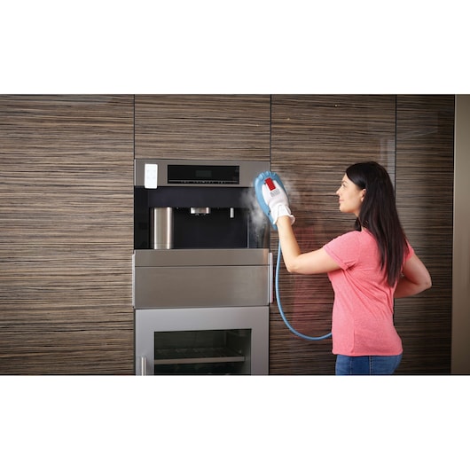 BLACKDECKER FSMH13101SM steam cleaning glove used to clean kitchen appliance surface.
