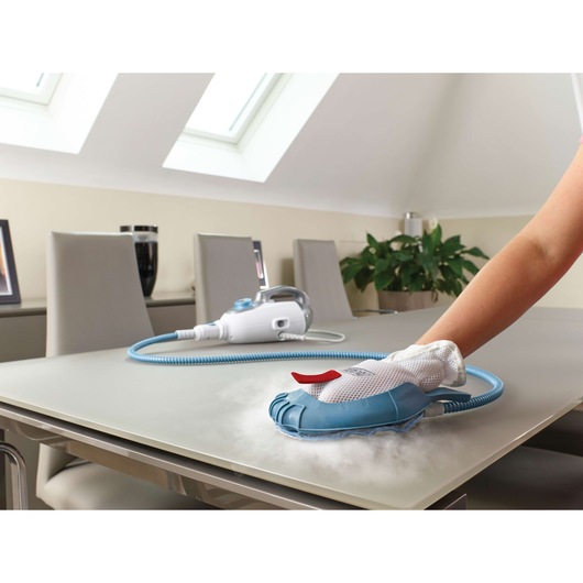 BLACKDECKER FSMH13151SM steam cleaning glove in use on table, home interior in background.