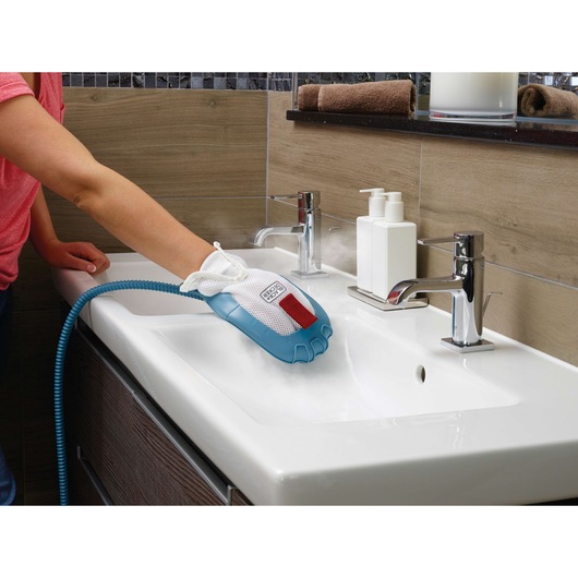 Photo of BLACKDECKER FSMH1351SM steam cleaning glove cleaning a bathroom sink with visible steam.