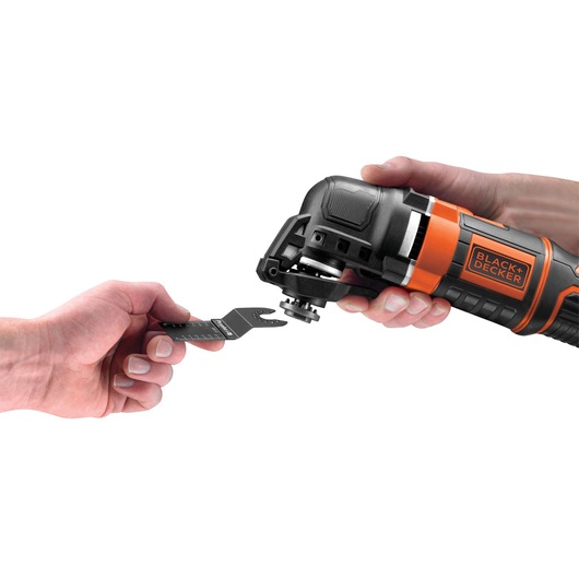 Photo of BLACKDECKER MT300KA multi-tool side view, hand installing accessory blade