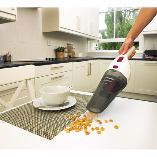 BLACKDECKER NV3620N handheld vacuum cleaning cereal from table in kitchen