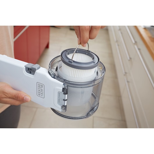 Photo of BLACK+DECKER PV1820L handheld vacuum filter being removed from dust container.