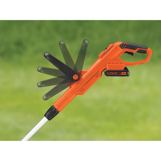 BLACK+DECKER STC1820 18V lithium battery-powered grass trimmer with adjustable head, shown against a blurred green lawn background.