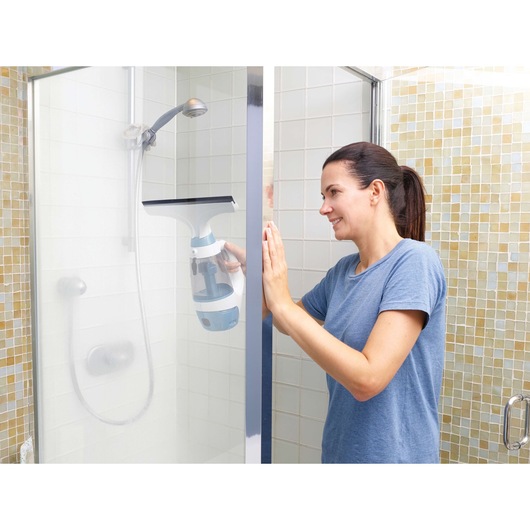 BLACKDECKER WW100 window vacuum cleaner used on shower glass in bathroom setting.